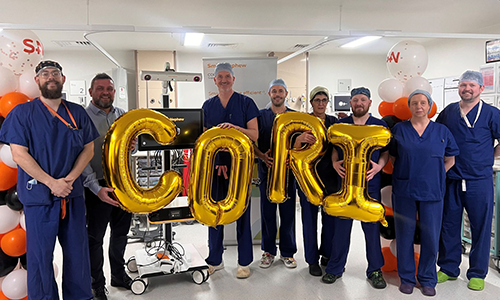 people in scrubs with CORI balloons